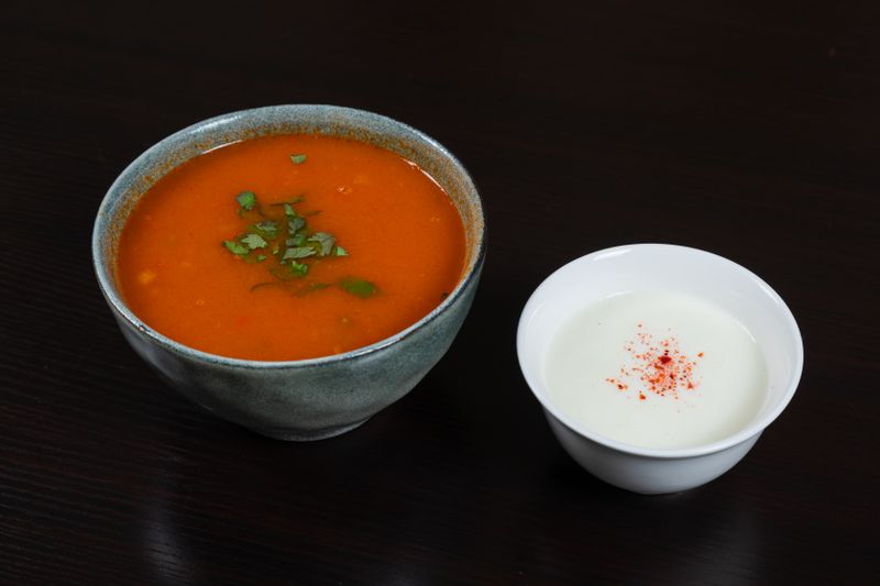 Creamy tomato basil soup in a white bowl